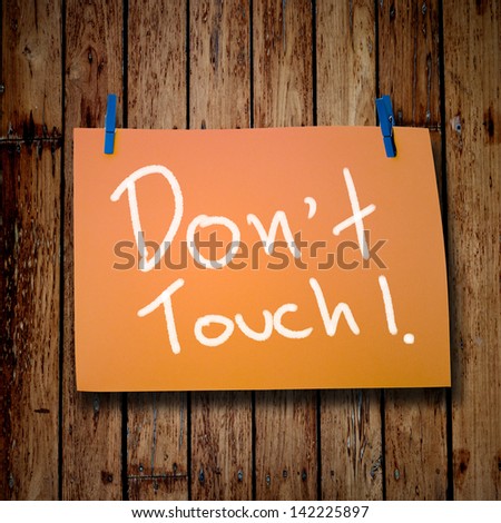 Don\'t touch message on wooden background