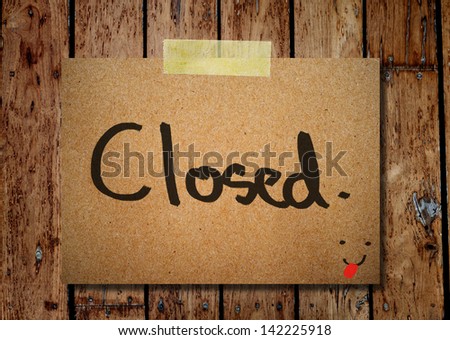 note paper and clothes peg on a wooden background with close message