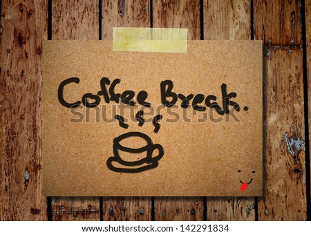 note paper and clothes peg on a wooden background with coffee break message