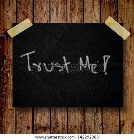 Trust me on message note with wooden background