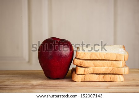 apple, bread on wooden floor