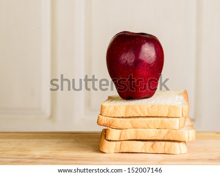 apple, bread on wooden floor