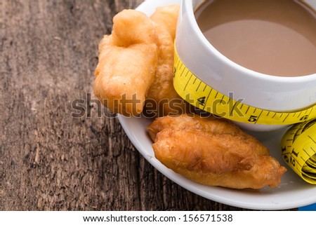 Deep fried dough stick, coffee and Measure tape