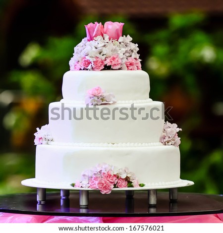 White four tiered wedding cake on table White four tiered wedding cake on table