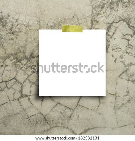 paper note with sticky tape on old wall texture