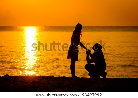 Silhouette Man knees ask woman to marry, love concept
