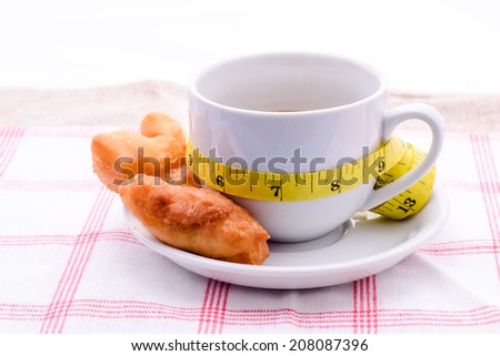 Deep fried dough stick, coffee and Measure tape,junk food concept