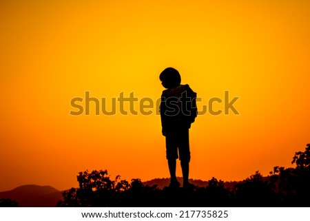 Girl standing on top hill during sun set