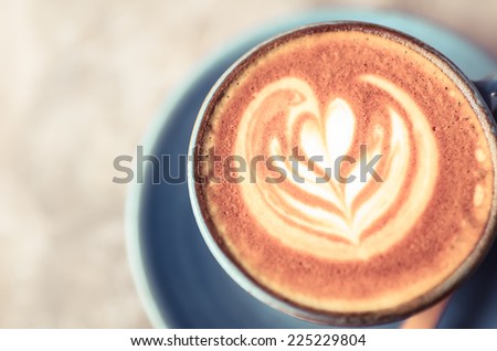 Latte art, Blue coffee cup on gray background and vintage colour effect.