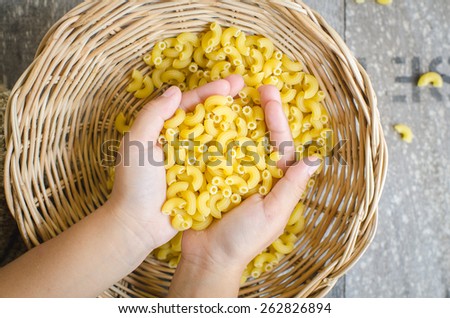 Italian Macaroni Pasta  in child hand.