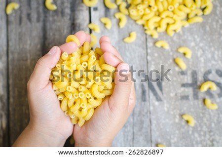 Italian Macaroni Pasta  in child hand.