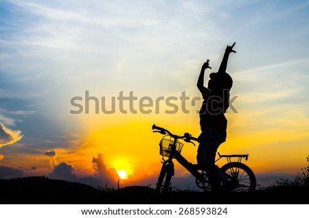 Silhouette of the cyclist riding a road bike at sunset