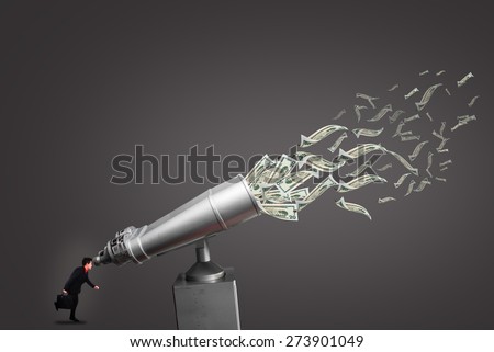 Businessman looking coin-operated binoculars attracting flying dollar bills, isolated on white.