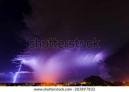Lightning thunder storm above village with dark background