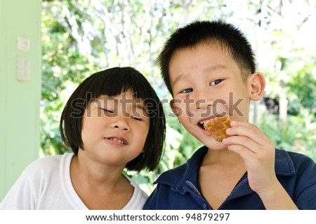 Happy brother and sister enjoy muffin