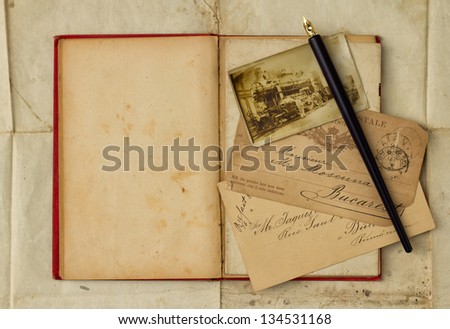 Background with vintage photo, postcards, and empty open book