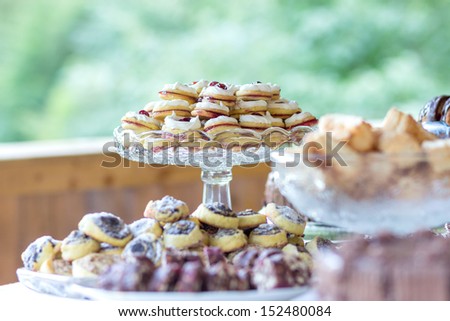 Table full of homemade cakes and cookies - nature background, outdoor decoration