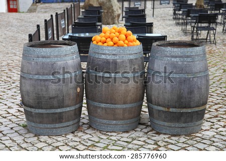 orange barrel in street cafe
