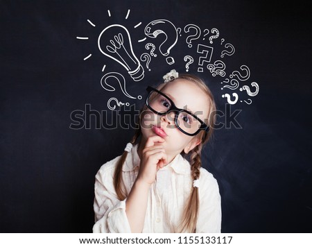 Cute child little girl with chalk lightbulb new idea symbol . Kid ideas and brainstorm