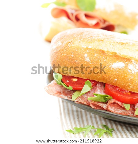 Snack food sandwich with salami and tomatoes