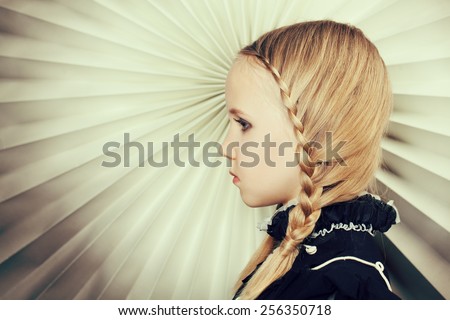 Girl with braids of blond hair, fine art portrait