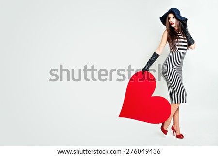 Young Beautiful Woman Holding Big Heart. Fashion Beauty Portrait. Background of Valentine\'s Day