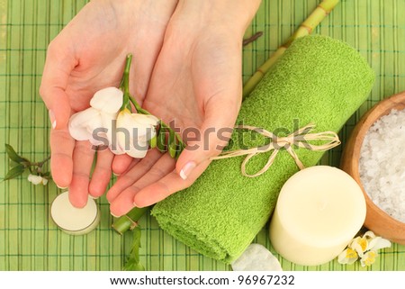 Hands spa - green background with flowers and bamboo