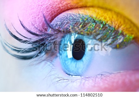 Young woman eye with makeup closeup. Vibrant colors.