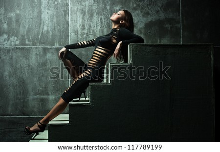 Young sexy woman on wall background.