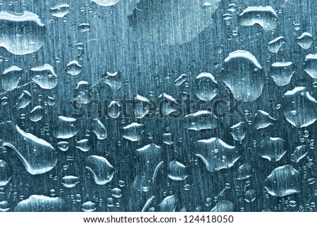 Water drops on metal. Soft blue tint.