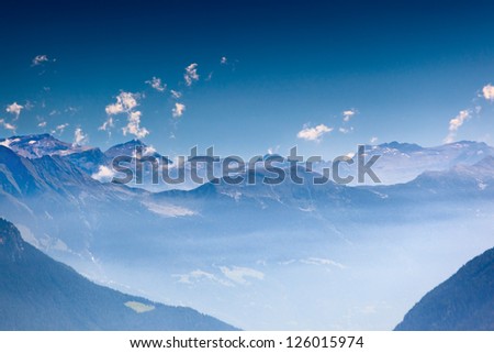 High mountains in haze. Soft blue tint.