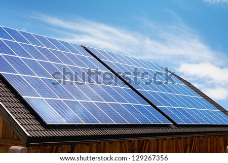 Modern solar panels on house roof in Europe.