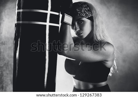 Young boxer woman portrait. Black and white film style colors.