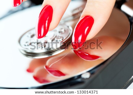 Young woman hand scratching hdd surface.