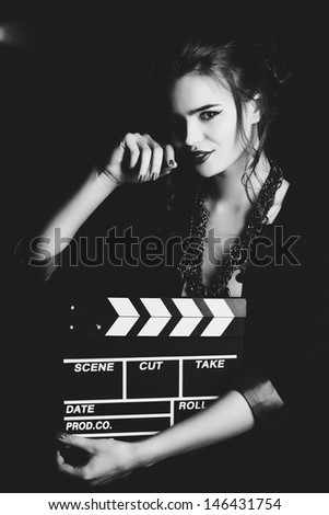 Young woman film director portrait. Film style black and white.