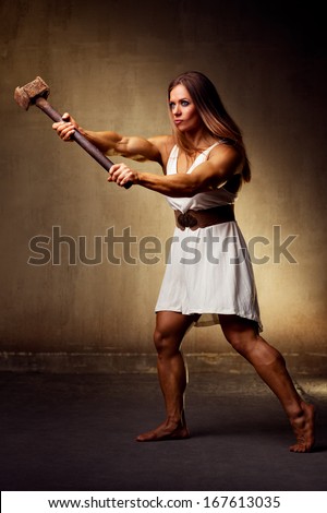 Young woman bodybuilder with hammer.