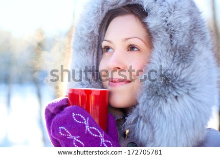 Young woman with warm mug winter portrait.