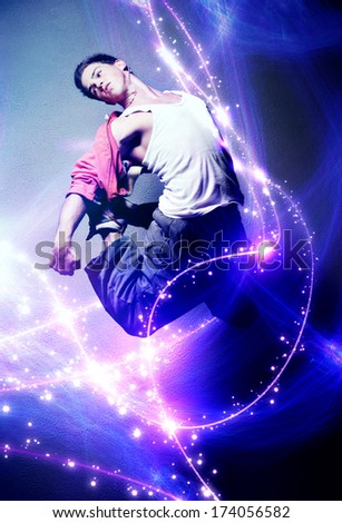 Young man dancer. With lights traces and sparks.
