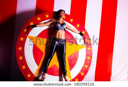 Young woman standing in circle for throwing knives.