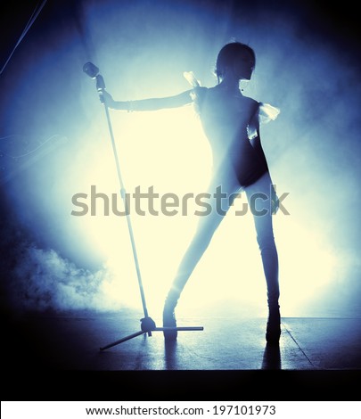 Young woman singer. Contrast silhouette.
