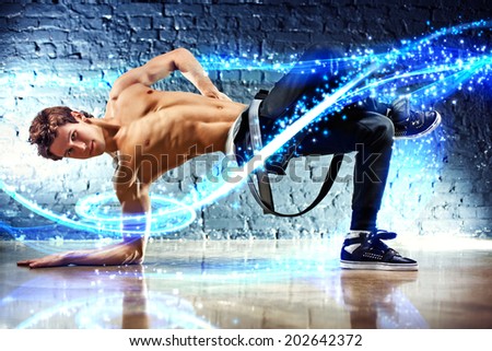 Young dancing man with light effects.