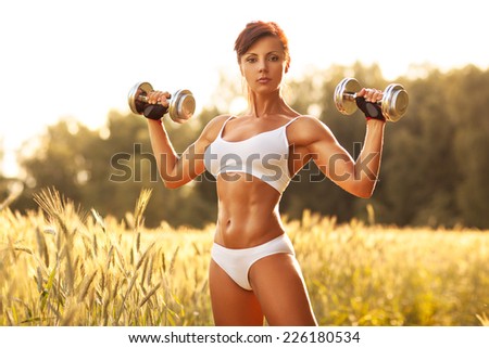 Woman sports training at summer field.