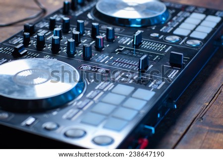 Dj mixer on wooden table close-up.