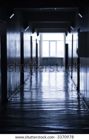 Dark corridor with bright window at the end. Blue tint.