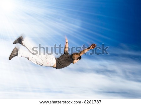 Flying man. Young man falling down on sky background.