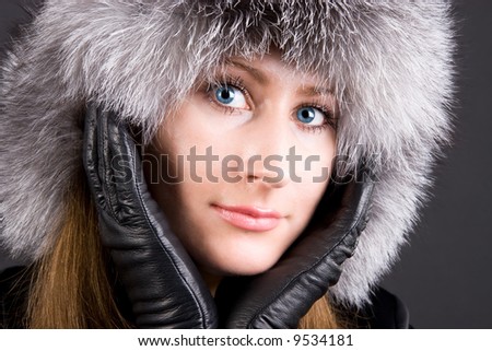 Young woman in big fur cap.