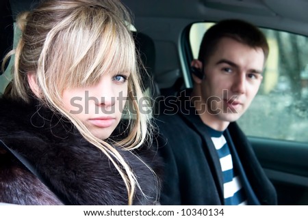 Couple in car. Young man and woman in car portrait.