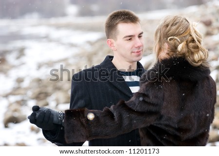 Couple in love dancing outdoors. Winter season.