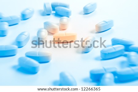 One special pill. Yellow and blue tinting. Small dof.