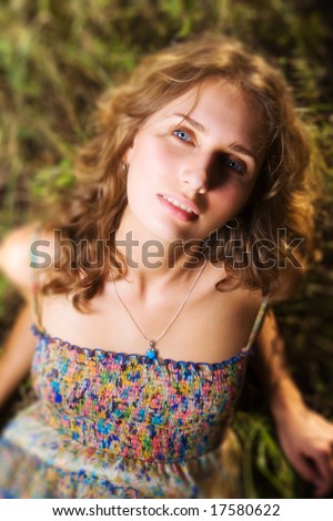 Young woman on a summer field. Shallow dof effect.